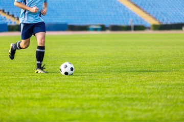 Running soccer player. Soccer football background.