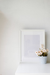 Photo frame and flower on table with copy space.