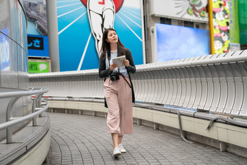 asian visitor walking on the bridge in Dontonbori.