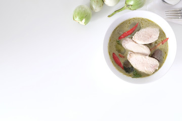 Green curry soup with top view on white table and copy space.