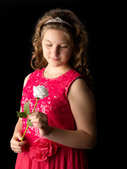 Teenage girl with a flower in her hand