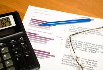 Glasses, Pen And Calculator On Performance Overview Close-up