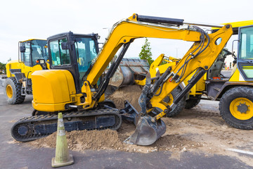 Front end loader dumping stone and sand at at constraction site