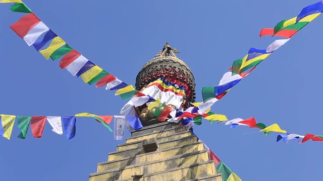 Prayer colorful flags flying from the Buddhist Stupa, a place of holy worship. Buddhist Temple in the Kathmandu valley, Nepal
