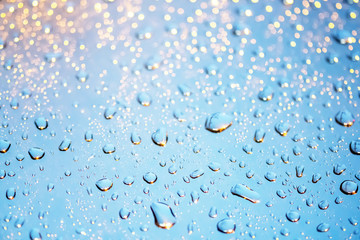 Beautiful water drops on window glass and many bokeh in night light. Water drops on rainy day  for background.