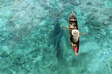 Fisherman in his boat  on turquoise sea