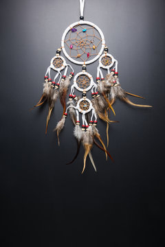 Dream catcher with feathers threads and beads rope hanging spiritual folk american native indian amulet isolated on black background.Copy space for text.Concept prevent evil in Halloween.