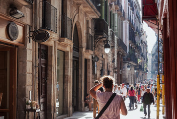 Busy street near Gothic Quarter shopping area in Barcelona - obrazy, fototapety, plakaty