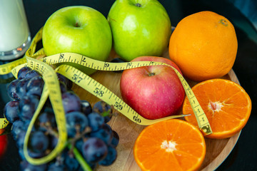 Health and beauty background. Colorful Mixing raw organic fresh fruity on tab;e. selective focus many fruity and measure detox diet concept.