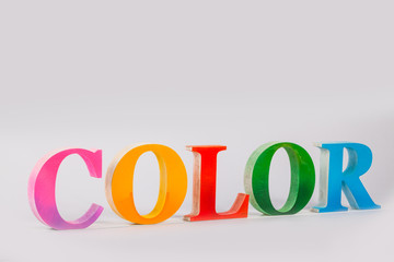 colorful character of the word color in white background with copy space
