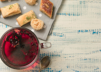 Fruit tea and oriental sweets on a wooden background.