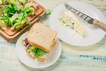 Vegetarian sandwich with salad and blue cheese on a wooden background. Healthy Diet