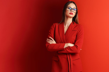 Fashion young woman in red suit.