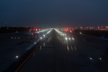 Fototapeta na wymiar Landing lights ON A airport runway at night time.