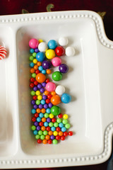 Closeup of colorful gumballs in a white dish