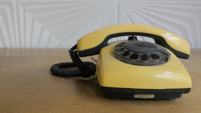 The retro yellow rotary telephone. Slider shot
