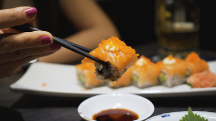 Chopstick roll  salmon sashimi in japanese restaurant