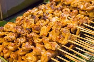 Pork chitterlings grill on banana leaf in walking street food Thailand.