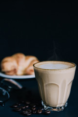 Latte art ,Croissant  with Roasted coffee on black background in the morning and instagram style filter photo vintage tone