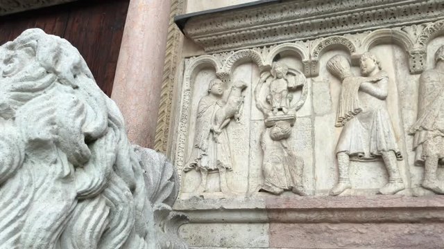 280818 Modena, Italy - sculptures on right side of Modena Duomo facade (UNESCO heritage site - Romanesque catholic church - stone Bible)