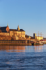 Fototapeta premium Oslo city skyline and harbor in front of Akershus Fortress during sunset in Norway