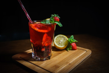 Fresh cocktail on a black background. Alcoholic cocktail on a black background. Fruit with a cocktail. Non-alcoholic cocktail. Mix of cocktails on a black background. 