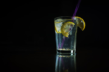 Fresh cocktail on a black background. Alcoholic cocktail on a black background. Fruit with a cocktail. Non-alcoholic cocktail. Mix of cocktails on a black background. 