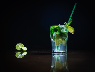 Fresh cocktail on a black background. Alcoholic cocktail on a black background. Fruit with a cocktail. Non-alcoholic cocktail. Mix of cocktails on a black background. 