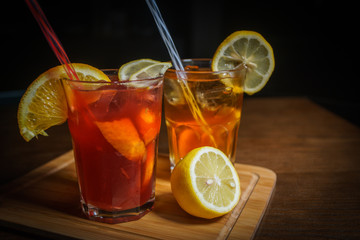 Fresh cocktail on a black background. Alcoholic cocktail on a black background. Fruit with a cocktail. Non-alcoholic cocktail. Mix of cocktails on a black background. 