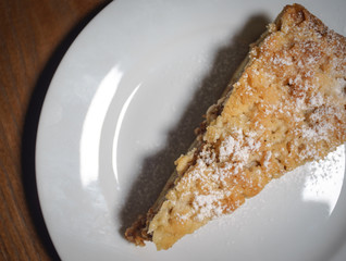 Piece of cake on a wooden board. Brownie. It's cake. Cake on a plate. A piece of cake on a plate with coffee.