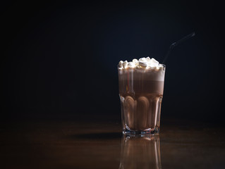 Coffee drinks on a black background. Coffee on a black table. Cold coffee. Latte. Cappuccino. Espresso. Coffee cocktails. Milkshakes. Whipped cream. Barista