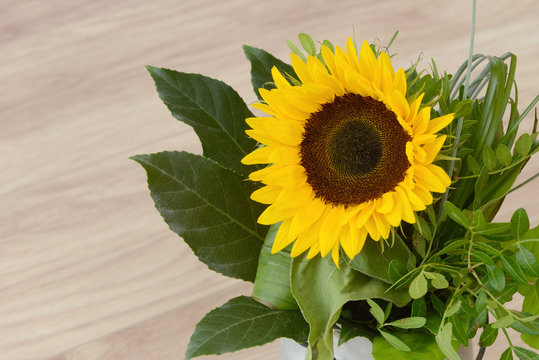 bouquet of sunflowers standing on wood