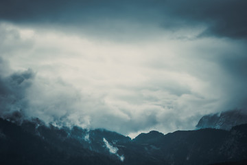 Panoramic view of the European Alps, dark, cloudy background concept