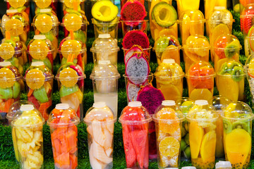 The fruit in the cup of fruit juice smoothie.