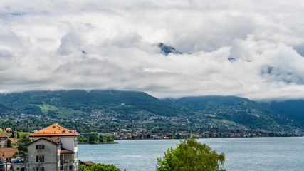 Fototapeta premium Switzerland, scenic view on Alps with fog, clouds near lake Leman