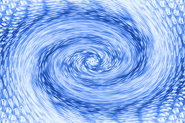 Space matter revolves around a spiral wormhole of cobalt color. Fantastic background image of asymmetric vortex tunnel in center of shot in blue.