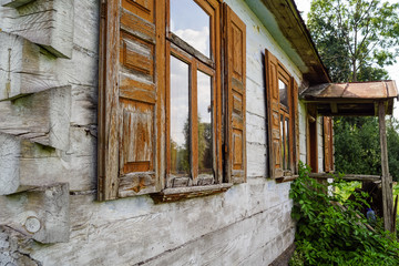 Windows with shutters in old wooden house, Poland