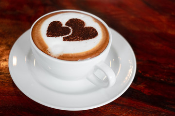 Closeup image hot capuchino coffee on vintage wooden table