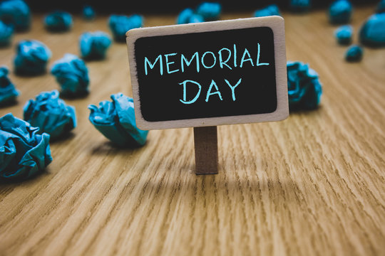 Writing note showing Memorial Day. Business photo showcasing To honor and remembering those who died in military service Blackboard crumpled papers several tries not satisfied wooden floor