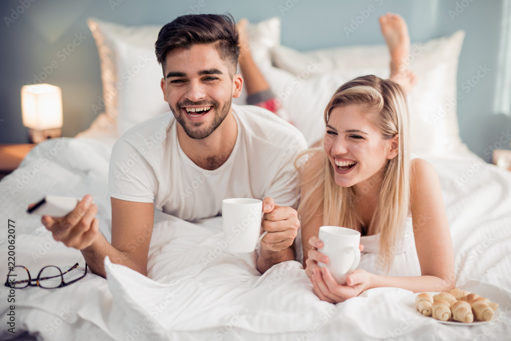 Wall mural Cute couple watching TV