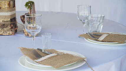 Banquet decorated table, with cutlery. Serving of a festive table, plate, napkin, knife, fork. Table setting decoration. Romantic Dinner or other events.