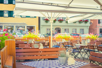 Table of a cozy tavern on the street at summer sunlight, traditional tourism vacation dining background concept