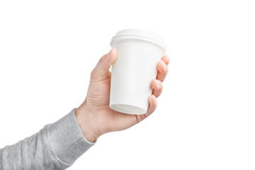 A paper cup of coffee in the hand. White paper cup of coffee in hand. For mock up. Isolated