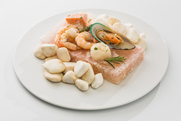 Seafood with garnish on a plate isolated on a white background
