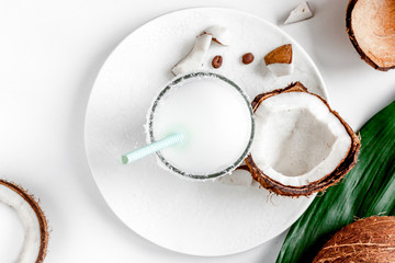 cocktail with coconut on white background top view