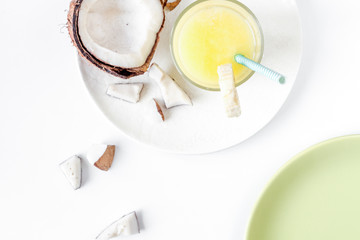 cocktail with coconut on white background top view