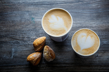 top view on two cups of coffee and three handmade cookies