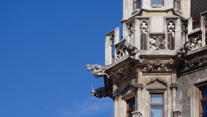 Detail of religious stone gargoyles on a tower in Munich, Germany