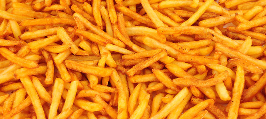 Crispy golden French fries background