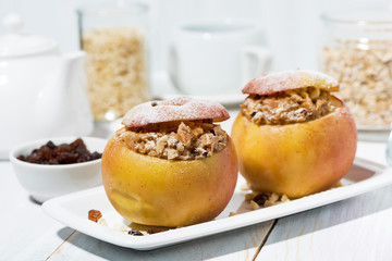 healthy breakfast. portioned oatmeal with raisins baked in apple